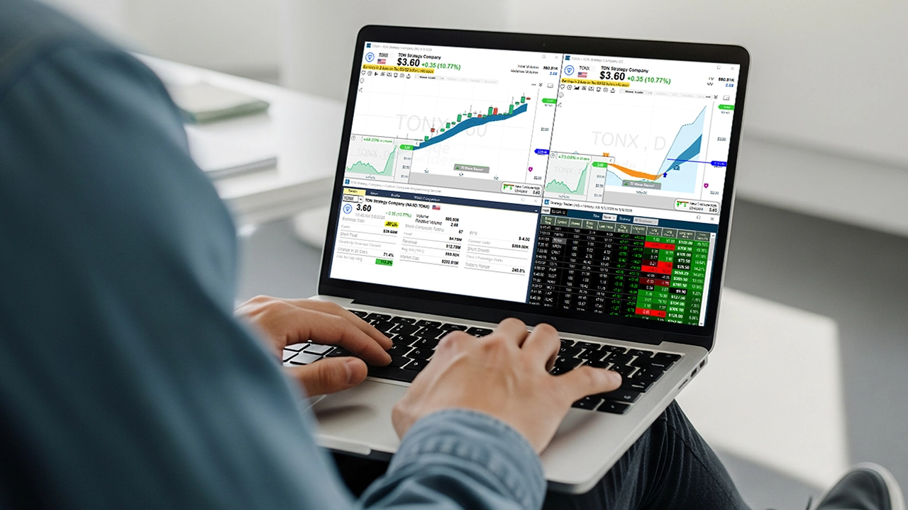 Trader using a laptop with a stock chart displayed